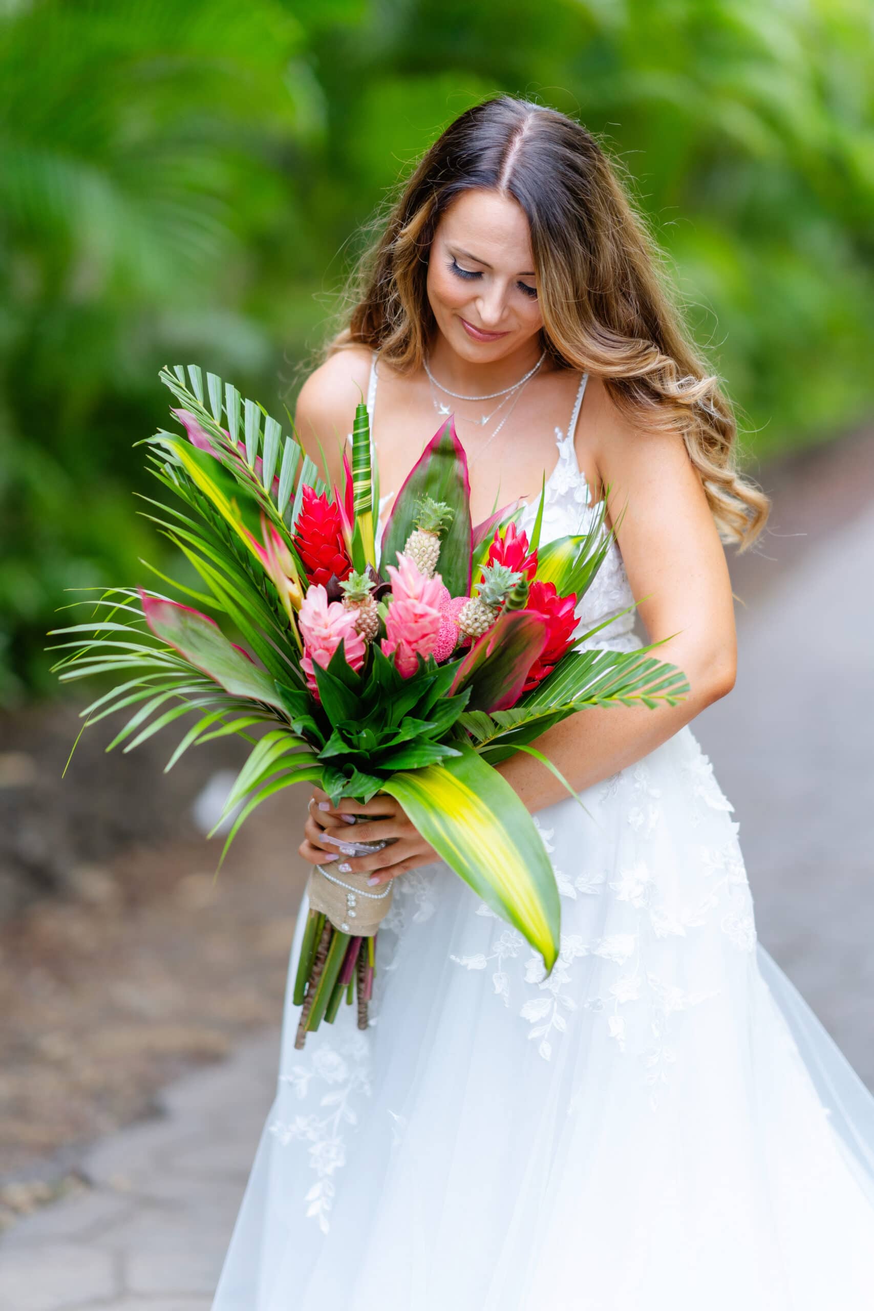 Bride holding tropical flower bouquet on Maui